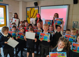 Children from the primary school show of their Brake Beep Beep! day road safety certificates