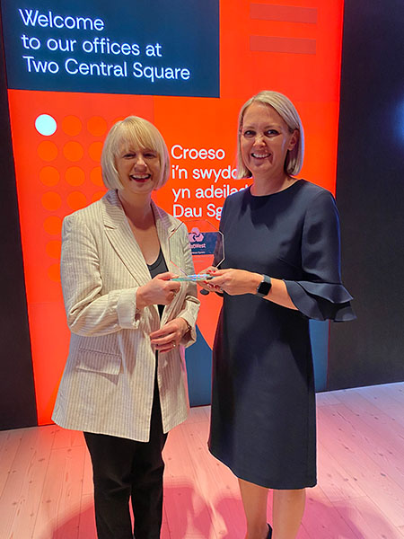 HR Director Di Brooks and Partner Gwen Morgan-Evans hold up the 2024 DE&I Change Maker awarded by NatWest's Cymru Board in Wales during the Powering up your future event