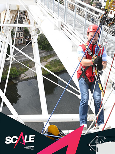 Construction Partner Matthew Stevens abseiling down the river side of Cardiff Principality Stadiums SCALE attraction.