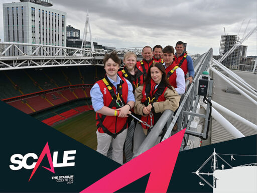 Font to back: Insurance paralegal Iuean Lewis, Construction solicitor Stevie-Jo Hinge, Digital communications manager Luke Dewhurst, a male work experience placement, Construction Partner Iwan Jenkins, Construction Partner Matthew Stevens, and Director of Business Division Ioan Prydderch walk around Principality Stadium’s rooftop wearing harnesses clipped to railings as part of SCALE's launch event.