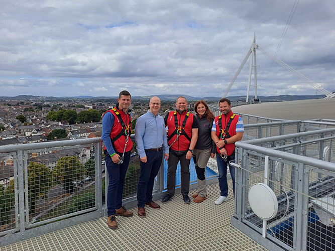 Left to Right: Hugh James Director of Business Division Ioan Prydderch, Pro Steel Engineering Director Richard Selby OBE, Hugh James Construction Partner Iwan Jenkins, SCALE General Manager Claire Jenkins, Hugh James Construction Partner Matthew Stevens stand atop SCALE, Principality Stadium’s rooftop adventure, overlooking Cardiff City Centre.