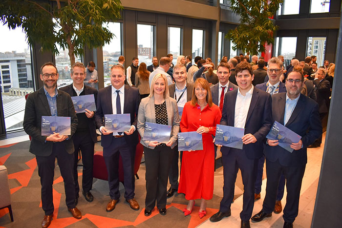 Partner Alex Madden stood with the speakers of the Western gateway rail deal panel in Hugh James' Cardiff office to celebrate the deal.